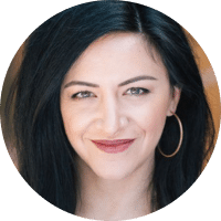 headshot of female provider with black hair and hoop earrings
